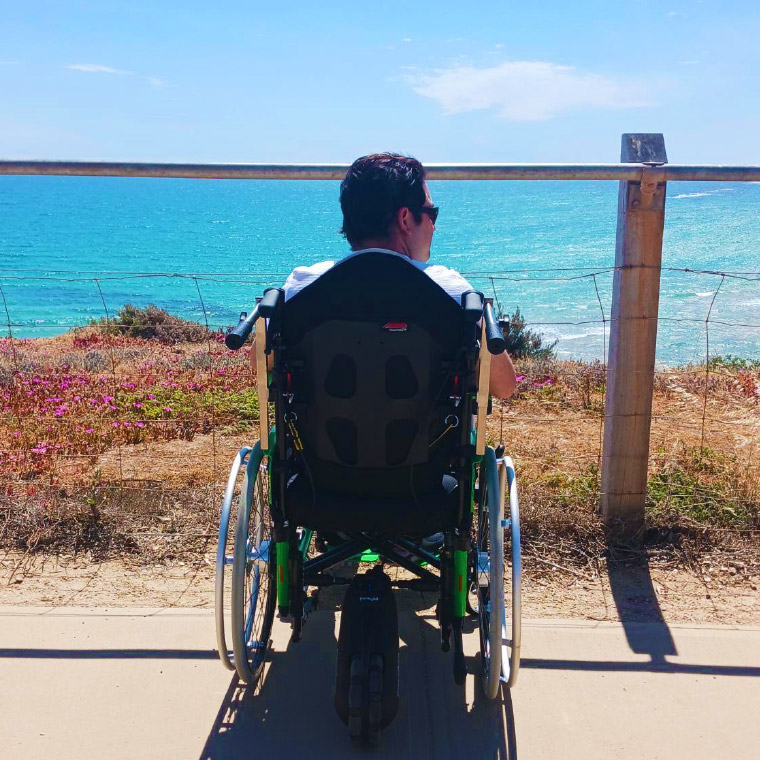 Elvin & Ellida enjoying the beach with the power assist feature of his wheelchair to make visting places easier.